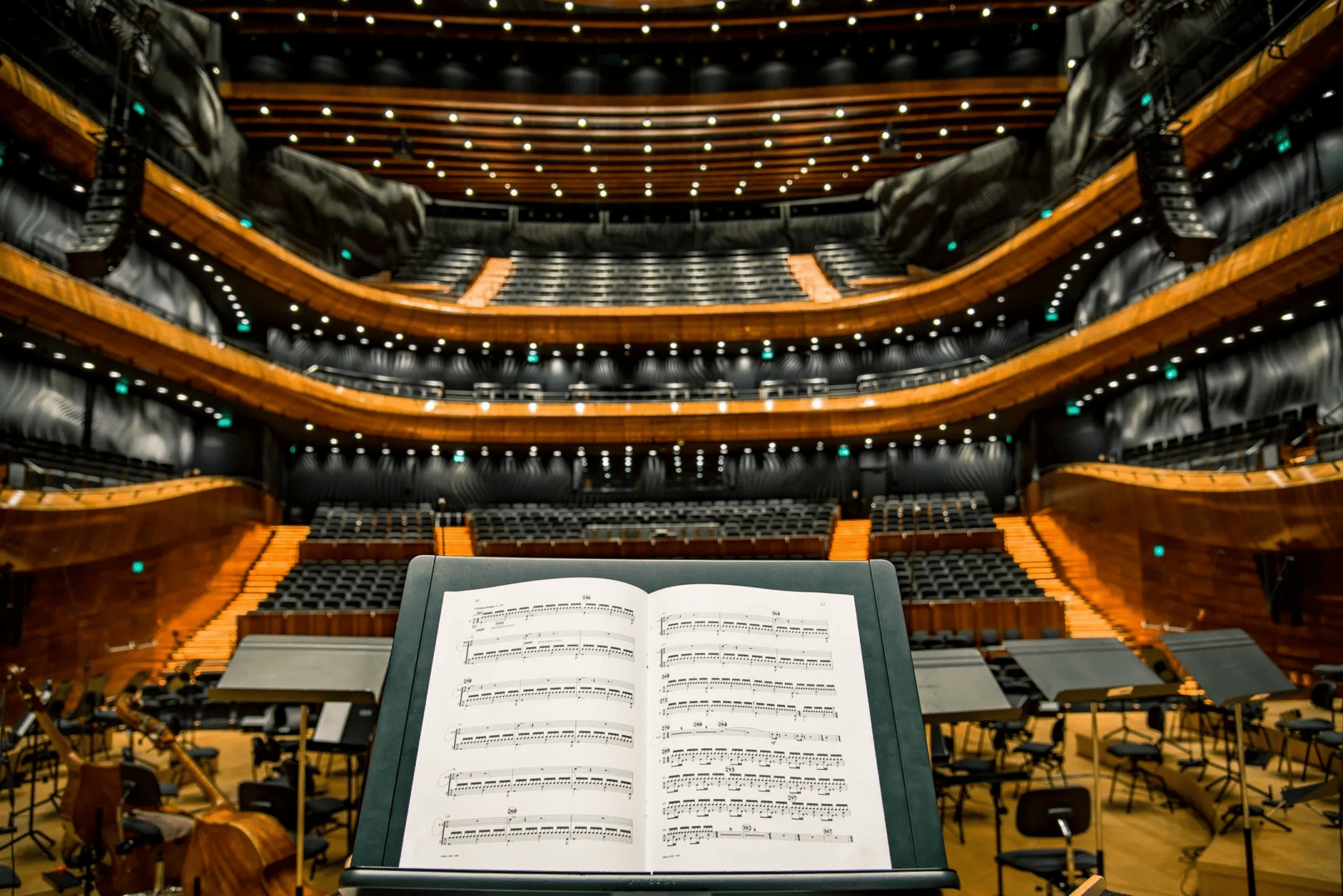 A book of sheet music is open in front of the orchestra.