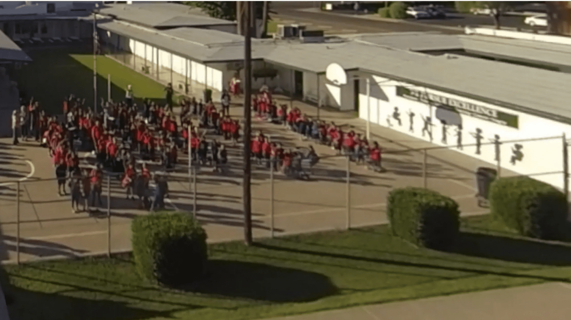 A group of people in red shirts and blue pants.